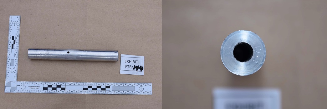 Image of the firearm that Dolphin was attempting to make. It shows a silver metal tube, approximately 20cm in length with a hole drilled about halfway along its length and with signs of working on the outside and inside.