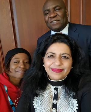 Toks Adesuyan (top right) and Varinder Hayre (bottom right) with a conference delegate