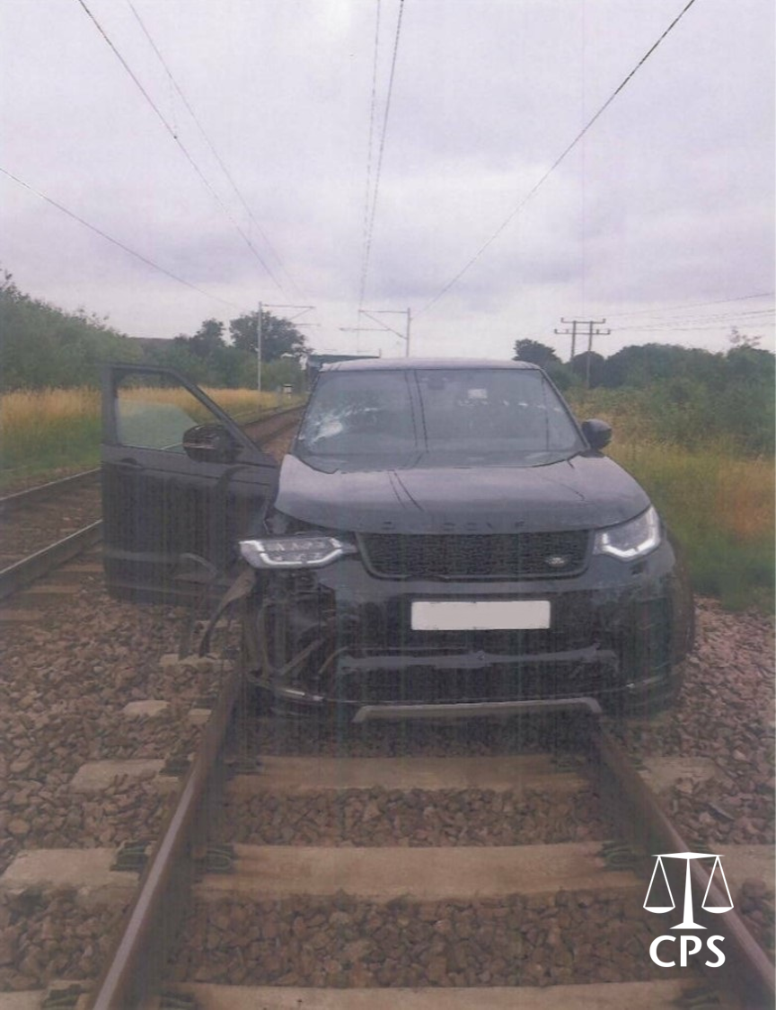 Land Rover abandoned on train tracks