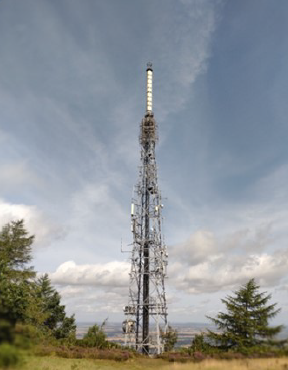 Photo of a red-and-white communications transmitter mast