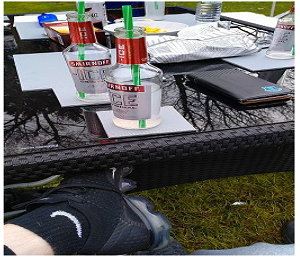 Garden table with bottles of alcohol