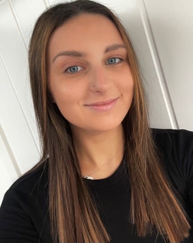 Photo of Maya smiling at the camera