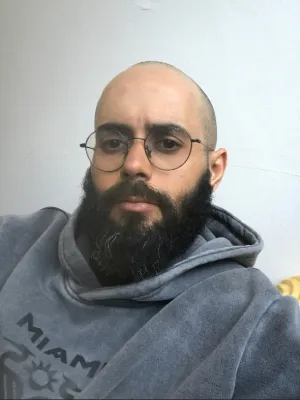 Abdullah Albadri, a man with a beard wearing glasses